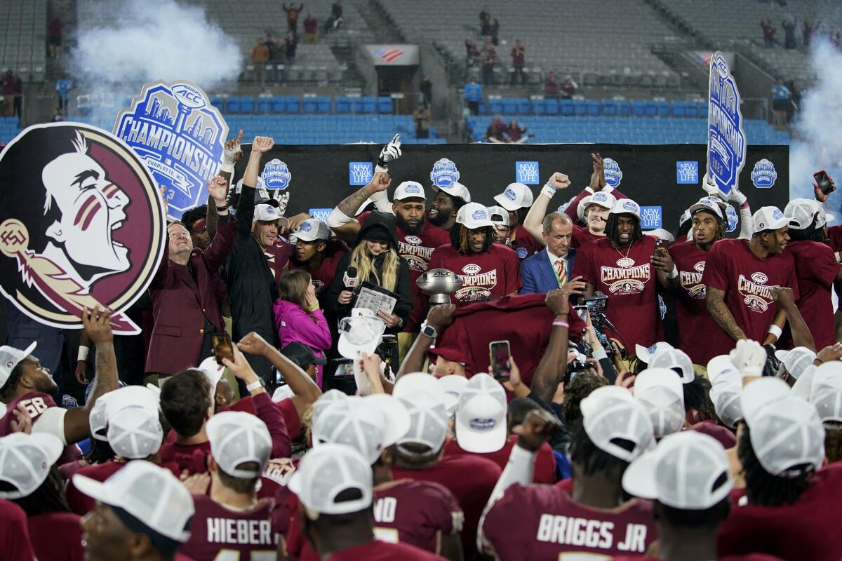 Florida State players celebrate after defeating Louisville in the ACC championship game on Saturday night.