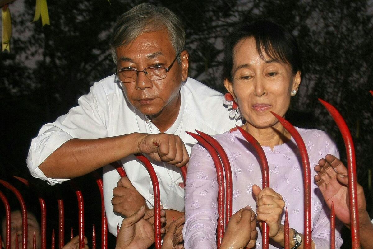 Htin Kyaw, a senior National League for Democracy official, stands with Aung San Suu Kyi at her residence in November 2010 on the day of her release from house arrest in Yangon.