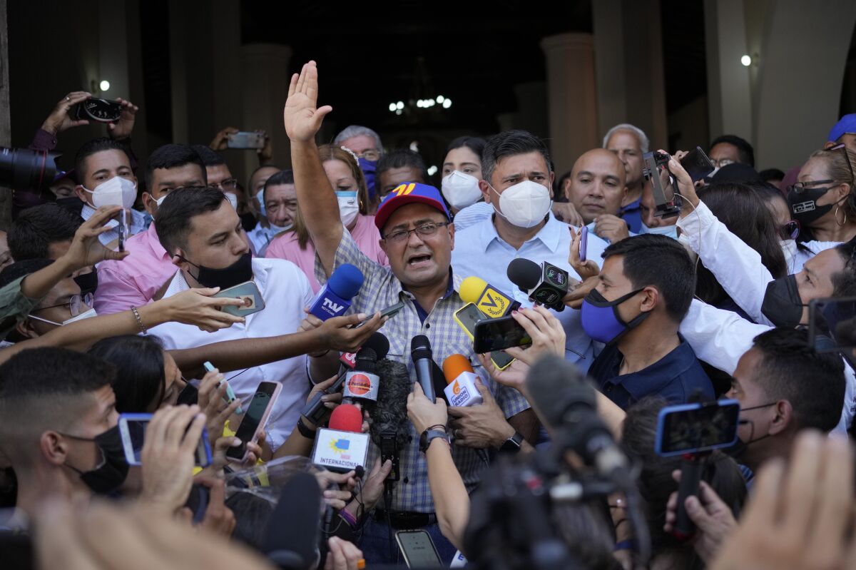Opposition governor-elect of Barinas state, Sergio Garrido, is surrounded by the press as he leaves a Mass the day after elections in Barinas, Venezuela, Monday, Jan. 10, 2022. (AP Photo/Matias Delacroix)