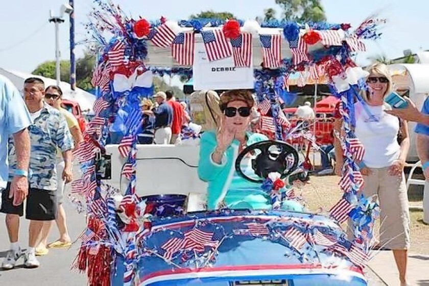 Debbie Baker drives her golf cart during the 2010 Cruisin' for a Cure car show. The 20th annual edition of the event returns to the OC Fair & Event Center Saturday.