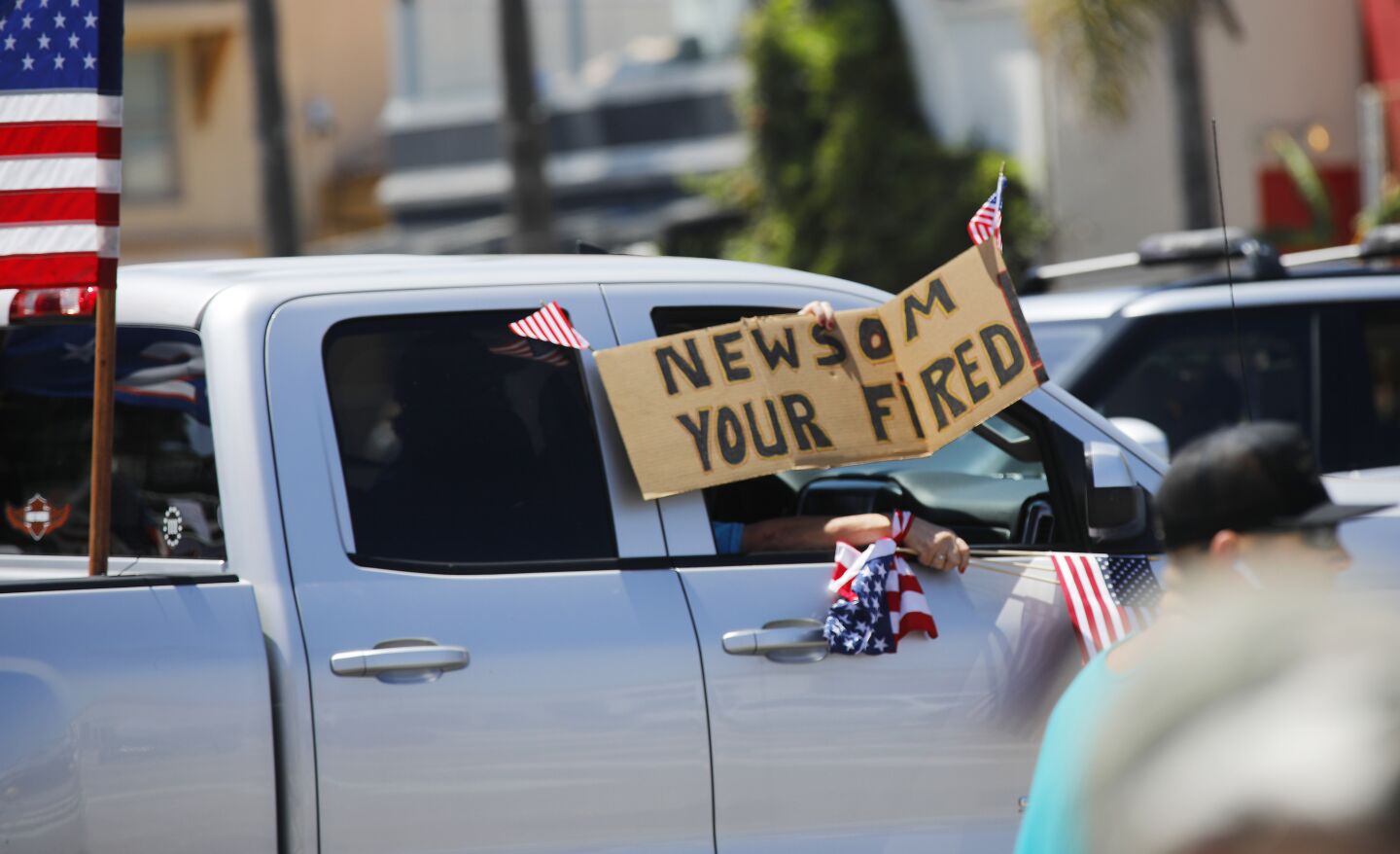 Protesters drive along Mission Blvd. in Pacific Beach during A Day of Liberty rally on Sunday, April 26, 2020. The protesters were against the government shutdown due to the coronavirus.