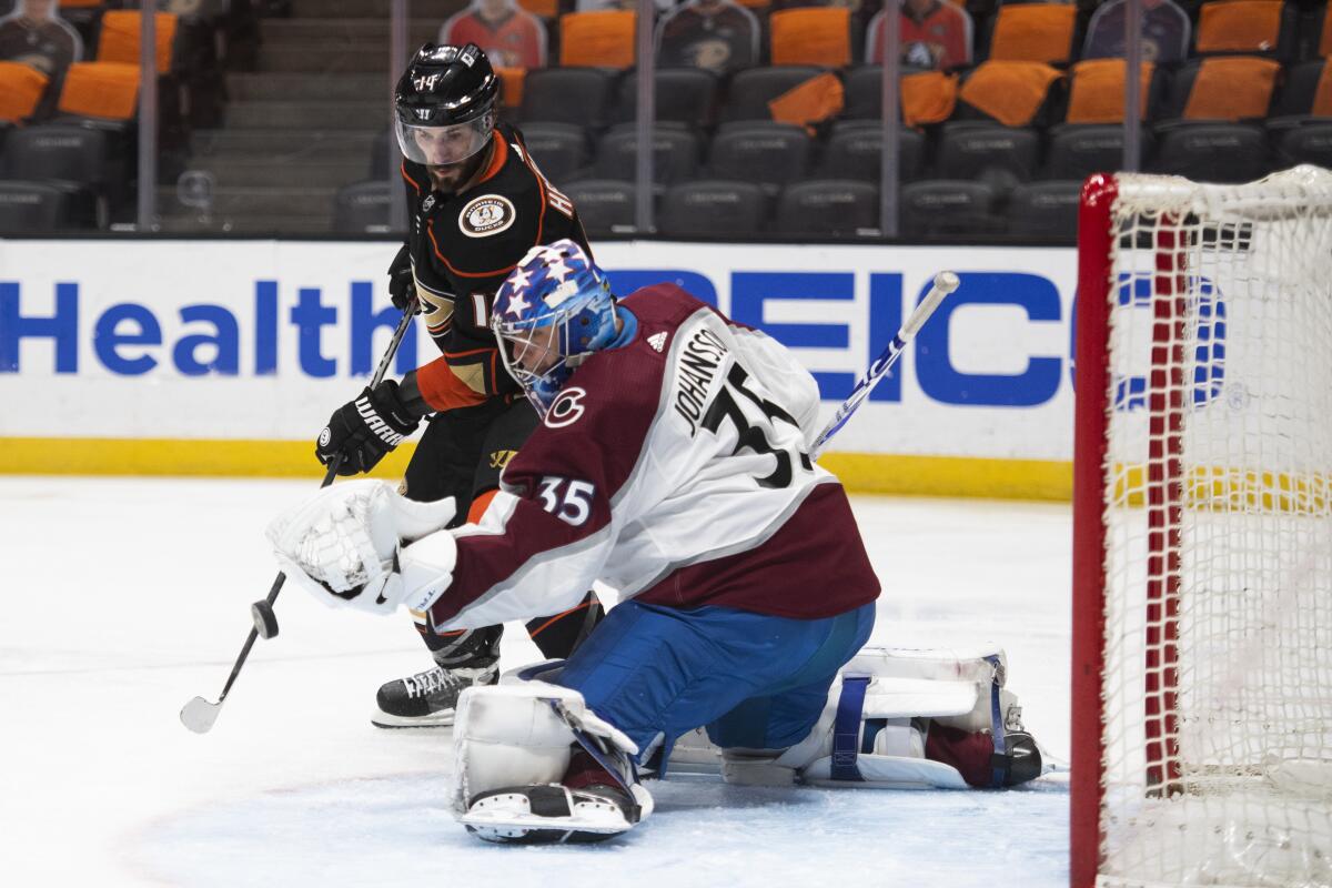 Ducks center Adam Henrique tries to deflect the puck in front of Colorado Avalanche goaltender Jonas Johansson.