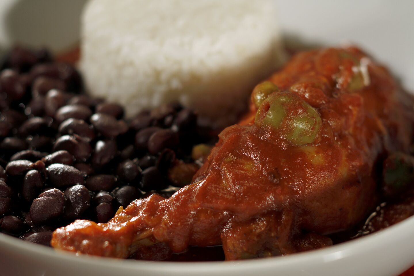 Tender, slow-cooked chicken stewed in a Creole-style tomato sauce dotted with green olives and peas and spiced with chile powder. Recipe: Pollo al Colmao
