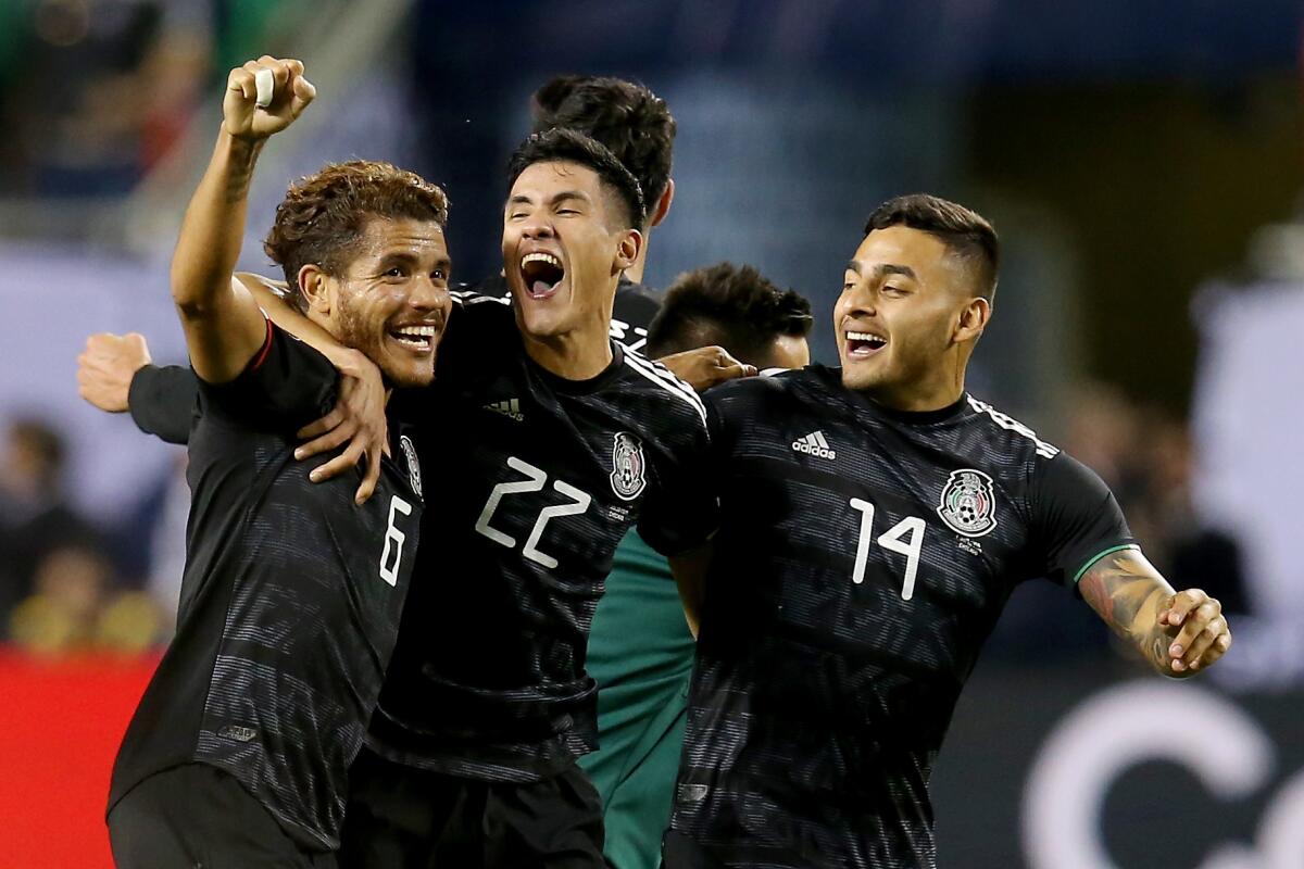 CHICAGO, ILLINOIS - JULY 07: Jonathan dos Santos #6, Uriel Antuna #22, and Alexis Vega #14 of the Mexico celebrate after beating the United States 1-0 in the 2019 CONCACAF Gold Cup Final at Soldier Field on July 07, 2019 in Chicago, Illinois. (Photo by Dylan Buell/Getty Images) ** OUTS - ELSENT, FPG, CM - OUTS * NM, PH, VA if sourced by CT, LA or MoD **