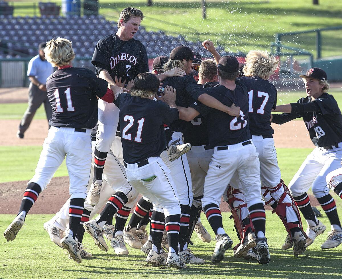 The Mission Viejo Diablos celebrate their win over Chino Hills in the Southern Section Division 2 baseball final Saturday in San Bernardino.