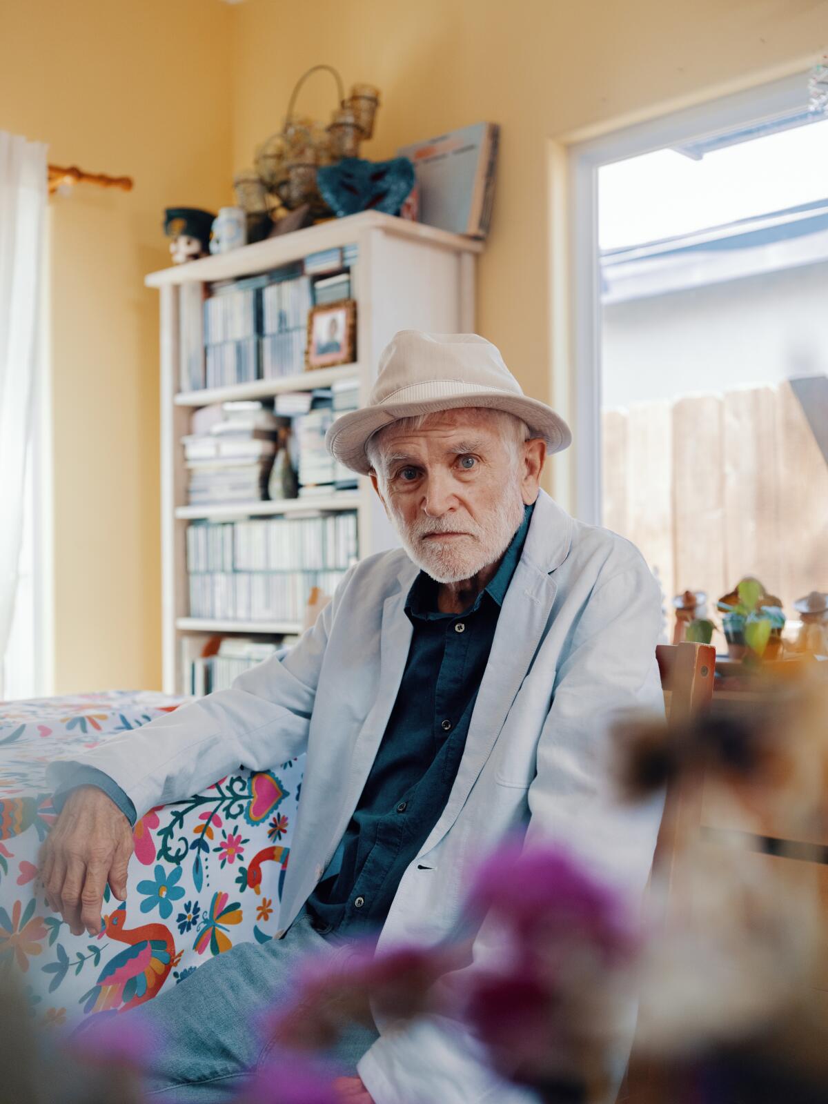 Mike Davis in a casual fedora and pale blue jacket.