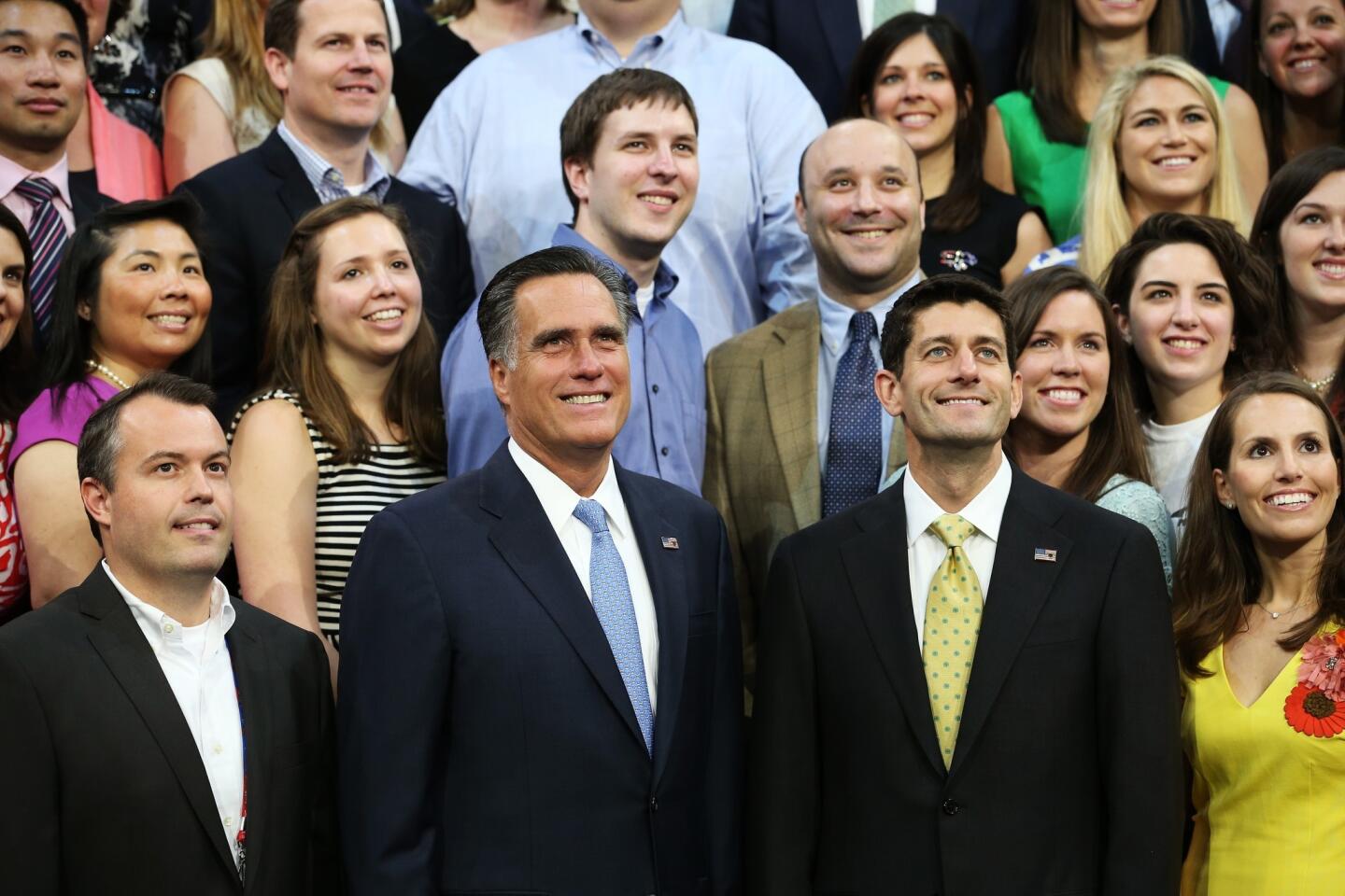 Republican presidential candidate Mitt Romney and vice presidential candidate Paul Ryan pose with campaign staffers during the final day of the Republican National Convention in Tampa, Fla.