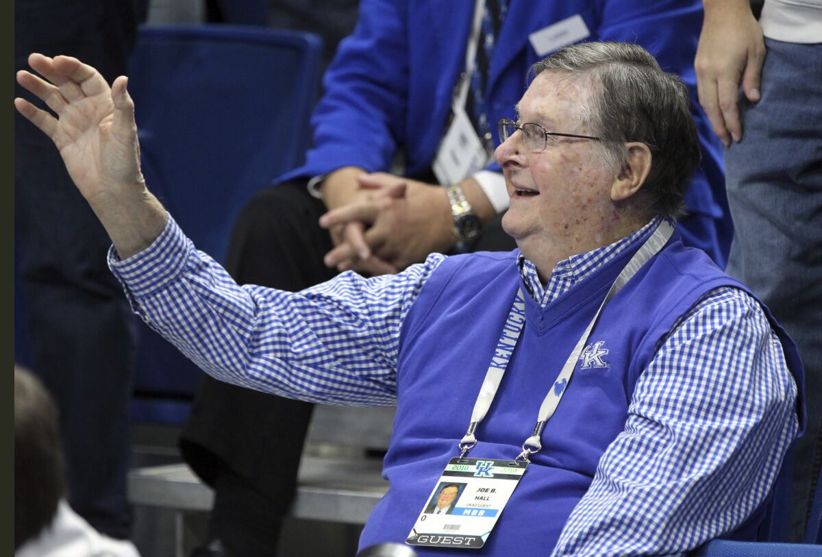 FILE - Former Kentucky coach Joe B. Hall waves to the crowd during the first half of the team's NCAA college basketball game against UAB in Lexington, Ky., Friday, Nov. 29, 2019. The former Kentucky basketball coach has died at age 93. The program announced Hall’s death in a social media post Saturday, Jan. 15, 2022 after the coach’s family notified current Wildcats coach John Calipari.(AP Photo/James Crisp, File)