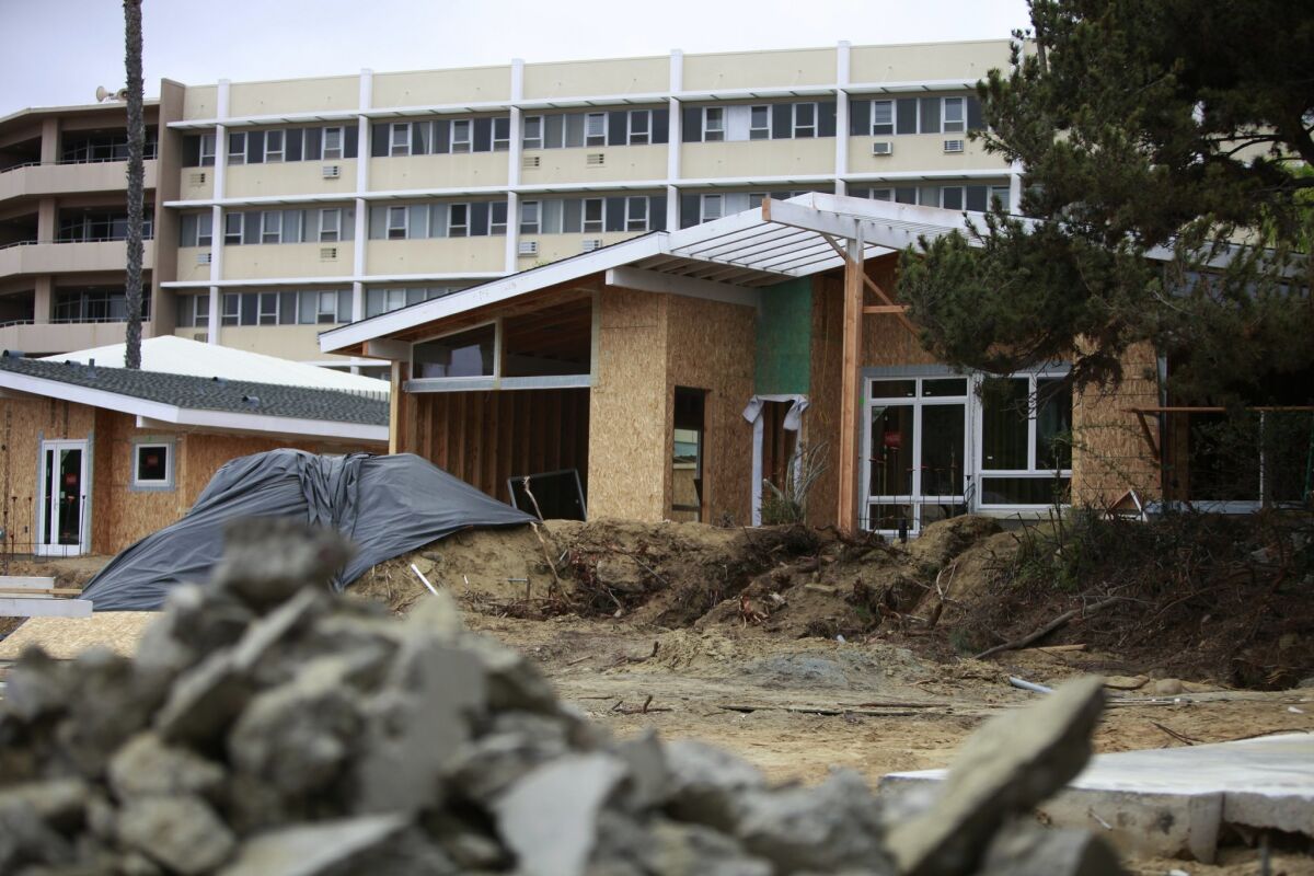 Beyond the patio homes is the six-story main building where 121 apartments are being upgraded. Giana Leone/UT