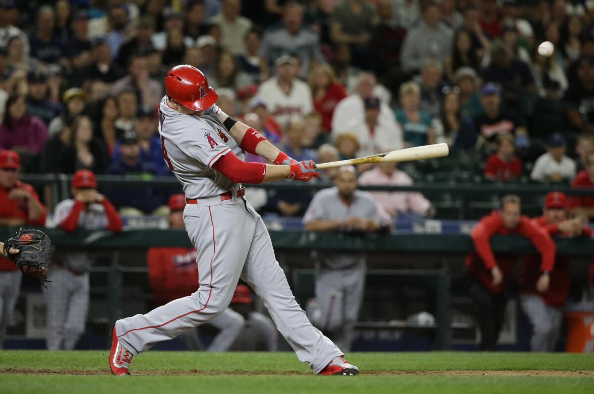 C.J. Cron hits a two-run single in the ninth inning of a game against the Mariners to give the Angels a 7-6 victory in Seattle on May 13.