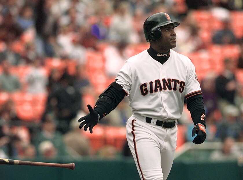 San Francisco Giants' Barry Bonds tosses his bat after hitting a two-run home run