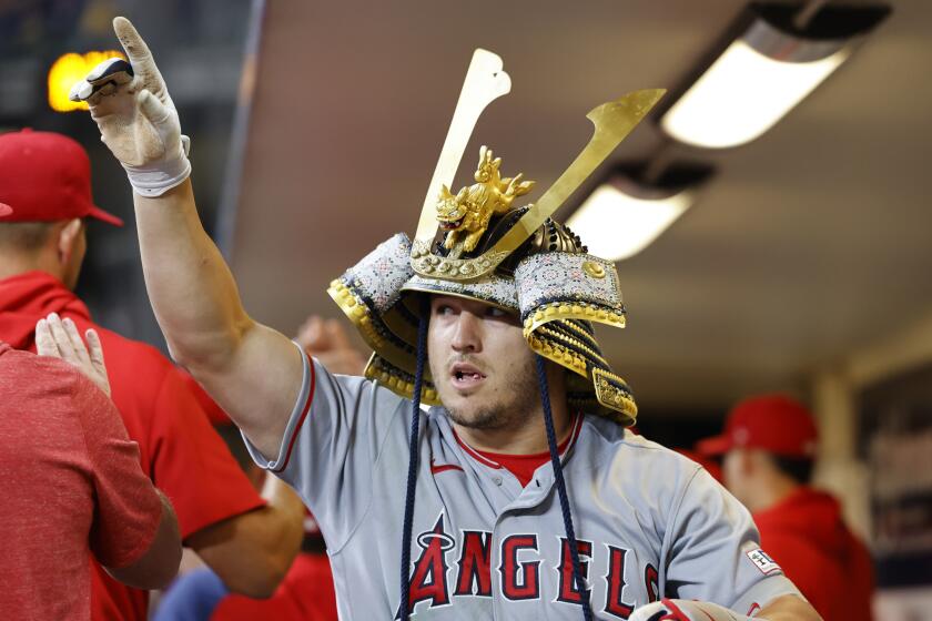 The Angels' Mike Trout reacts in the dugout after his two-run home run in the ninth inning April 29, 2023, in Milwaukee.