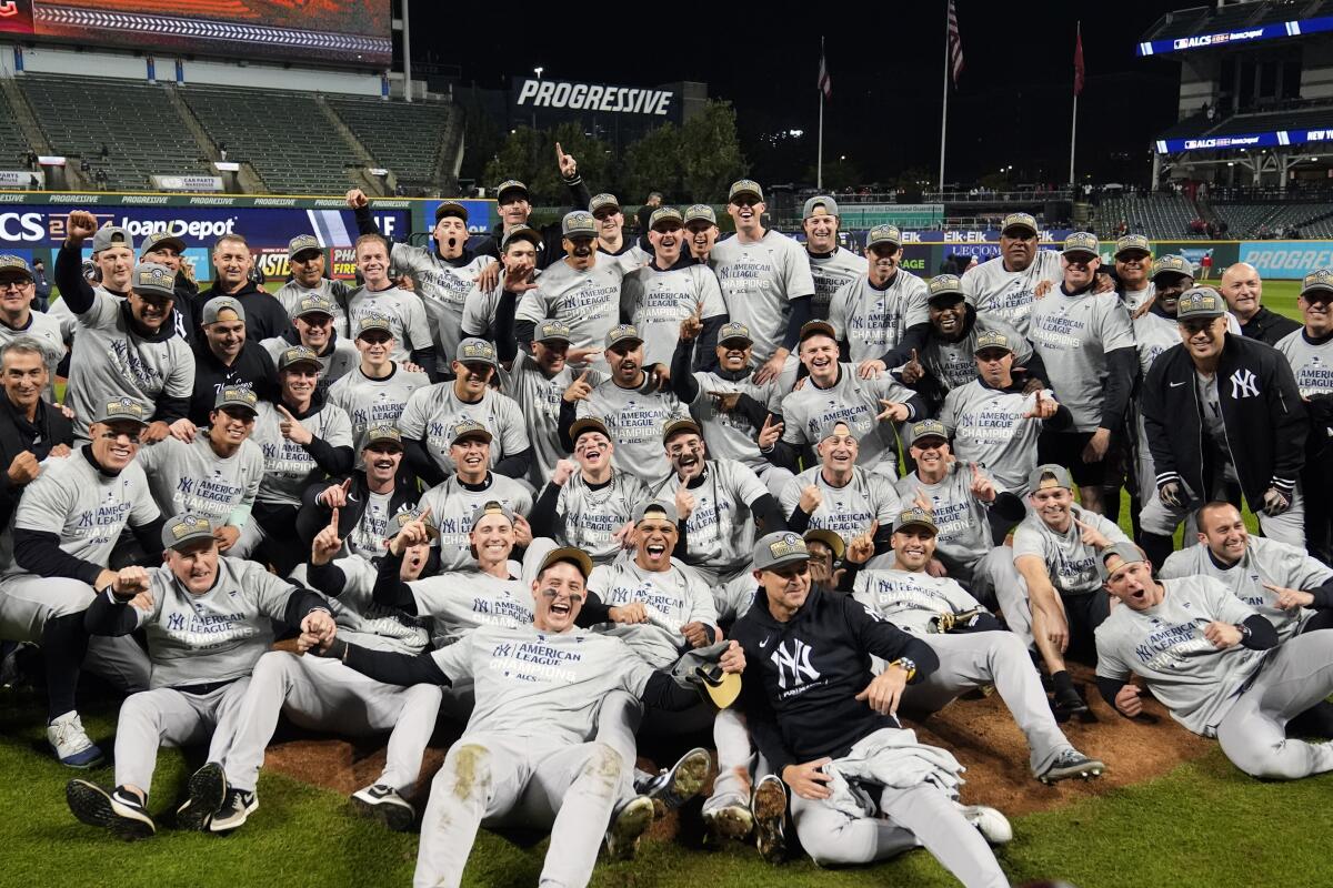 New York Yankees players celebrate after defeating the Cleveland Guardians in Game 5 of the ALCS.