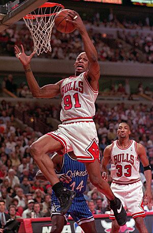 Two years after signing with the Spurs, Rodman joined the Chicago Bulls. In this photo, Rodman grabs one of his 21 rebounds during the fourth quarter of Game 1 of the NBA Eastern Conference Finals against the Orlando Magic in 1996.