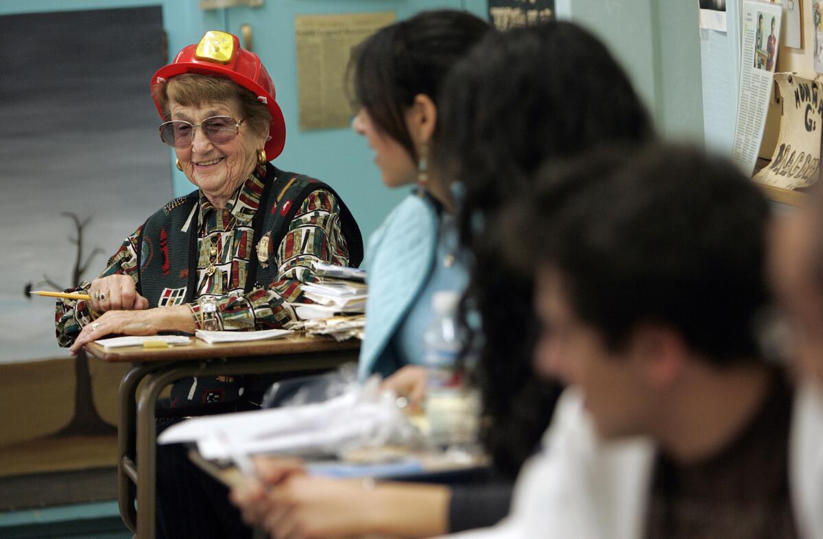 English teacher Rose Gilbert, shown in the classroom in 2007, often wore a fire helmet to show her Pali High students that she was "on fire." Gilbert died Dec. 16 at age 95.