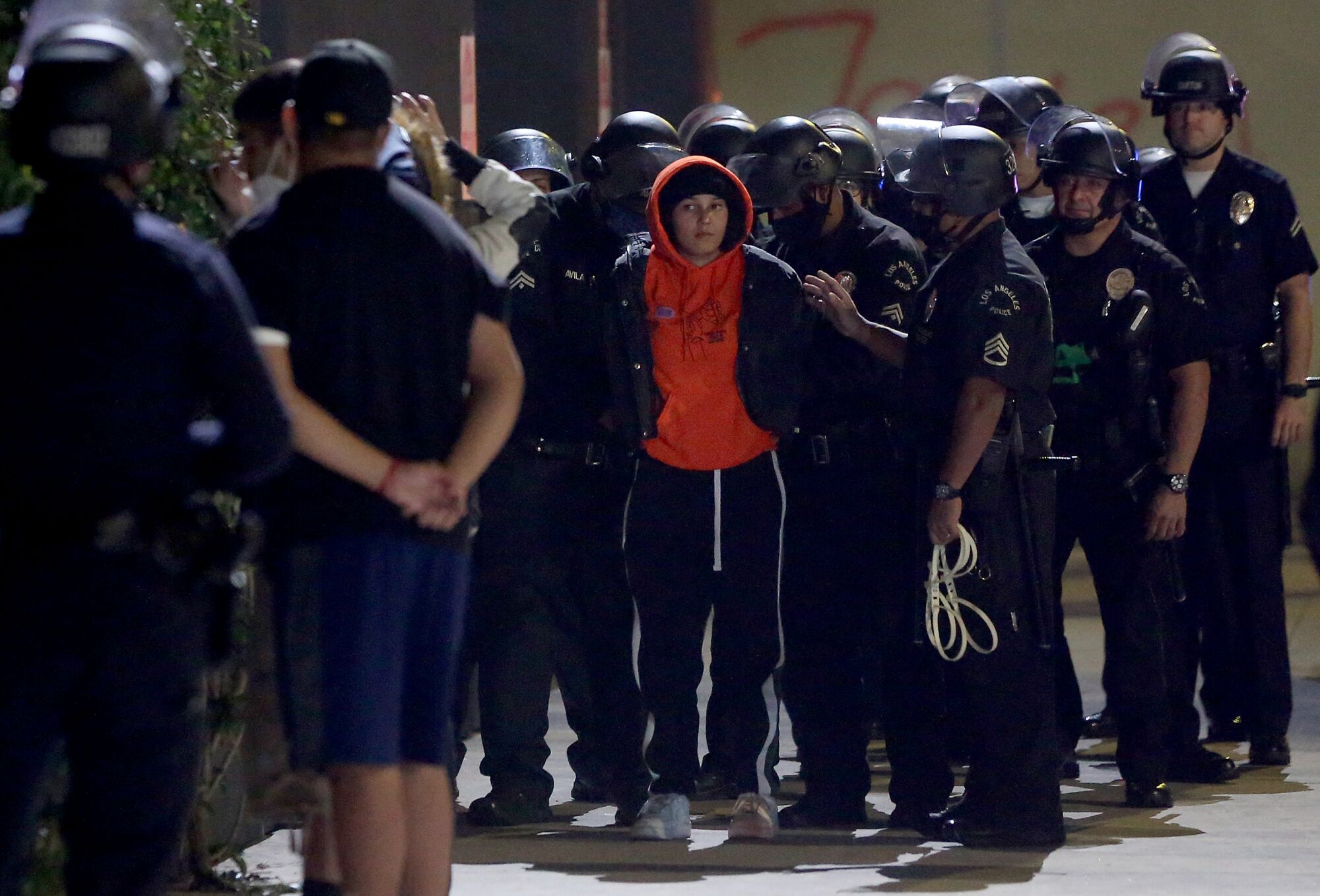Police detain protesters near 18th and Figueroa streets in downtown Los Angeles on Tuesday night.