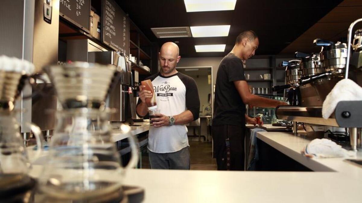 Staff from WestBean Coffee Roasters serve customers a variety of coffee drinks in their downtown San Diego cafe.