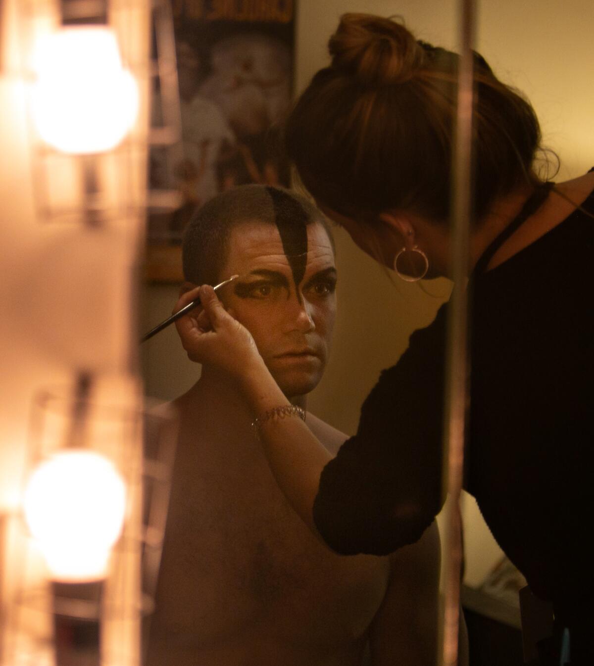 Max Westwell, who alternates as the Swan, has the signature Bourne makeup applied backstage. 