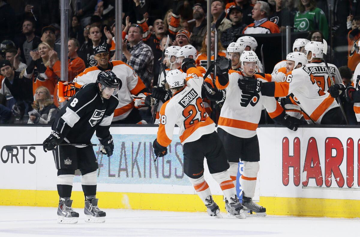 Kings defenseman Drew Doughty skates by the Flyers bench as they celebrate a win earlier this season. Doughty has been forced to play the second most minutes in the league.