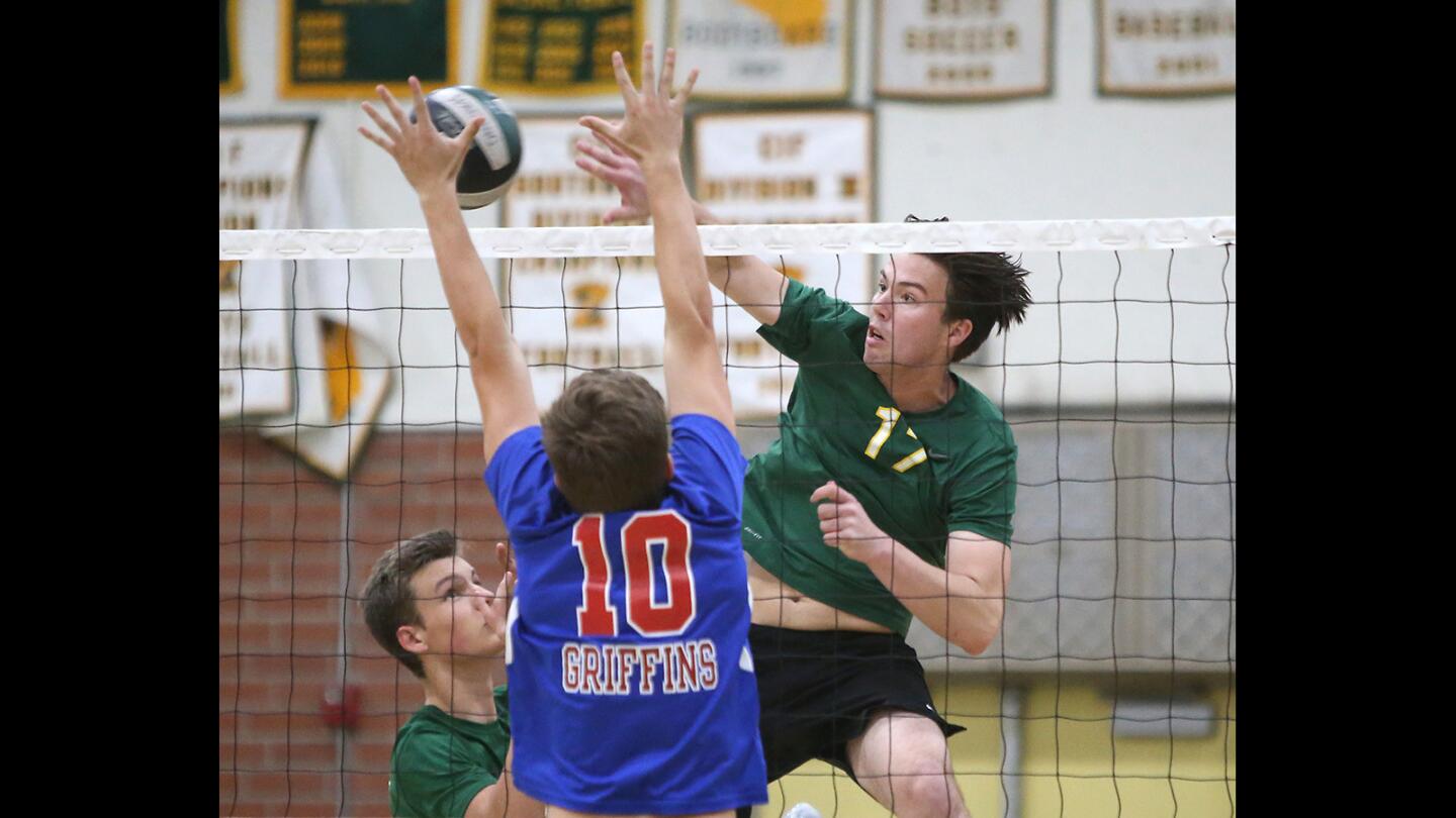 Edison High's Trevor McKay (17) hits a quick set for point during a boys' volleyball match against Los Alamitos on Tuesday.