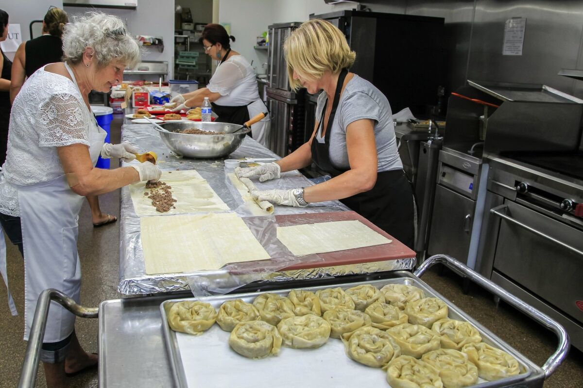 Cooks (from left) Ljubinka Plavsic, Dusanka Amanovic and Nada Milicevic prepare meat burek, one of many Serbian dishes being prepared for the annual festival at St. George Serbian Orthodox Church. — Eduardo Contreras
