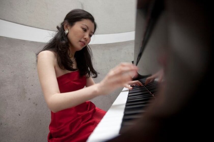 Psychologist Chia-Jung Tsay, pictured here at the piano, always wondered how much audiences (and competition judges) were influenced by what they saw, as opposed to what they heard. Quite a lot, her research shows.