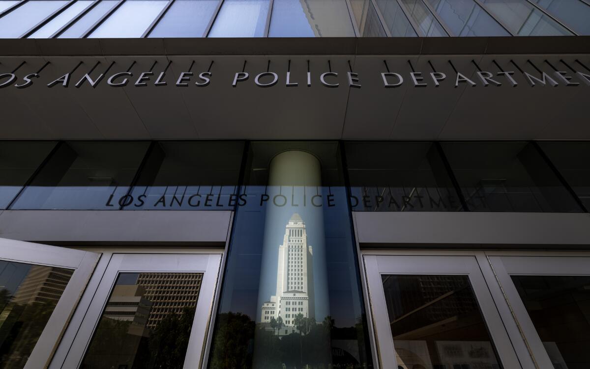 Los Angeles City Hall tower reflected above LAPD headquarters