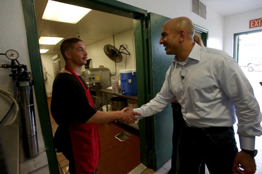 Republican gubernatorial candidate Neel Kashkari tours the Fresno Rescue Mission. Kashkari opposes Gov. Jerry Brown's plan to build a high-speed rail system between the Bay Area and Southern California. The mission is next to the proposed route of the trains.