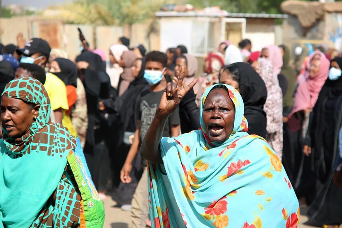Pro-democracy protester flashes victory sign in Khartoum, Sudan