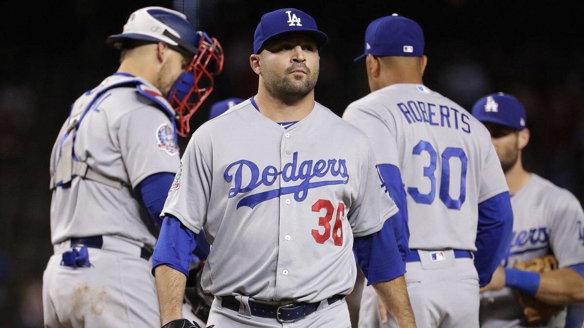 Dodgers relief pitcher Adam Liberatore (36) is pulled form the game by manager Dave Roberts (30) after giving up a two-run triple against the Arizona Diamondbacks on Tuesday.