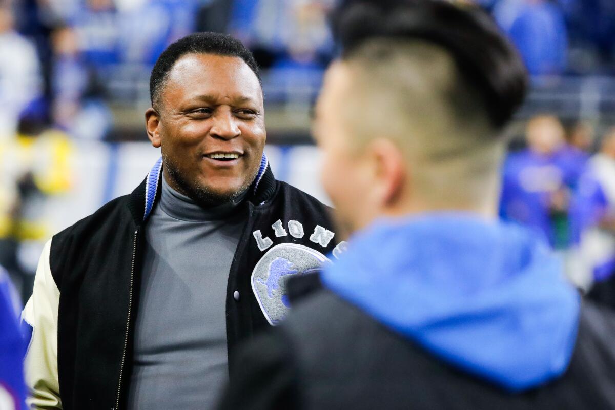 Former Detroit Lions running back Barry Sanders chats on the field before the Lions hosted the Rams. 