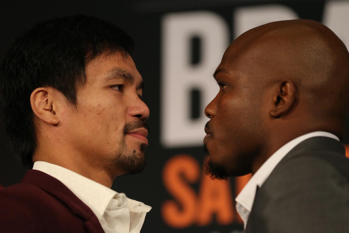 Timothy Bradley, right, and Manny Pacquiao promote their third fight during a news conference at the Beverly Hills Hotel on Jan. 19.