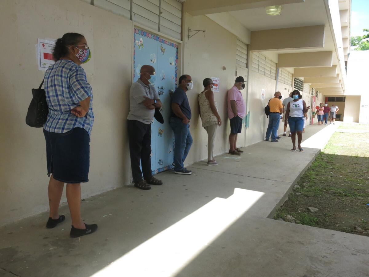 Voters wait to cast their ballots in Loíza, Puerto Rico, on Sunday. 