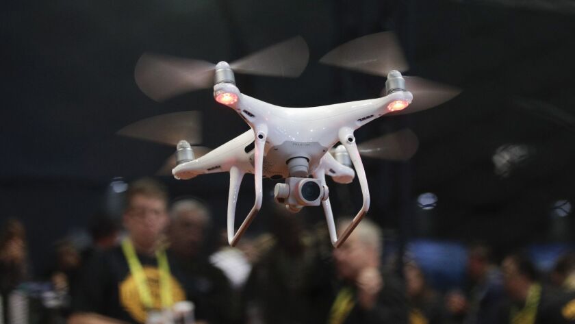 An exhibitor demonstrates a drone flight at the CES International convention in Las Vegas in January 2017.