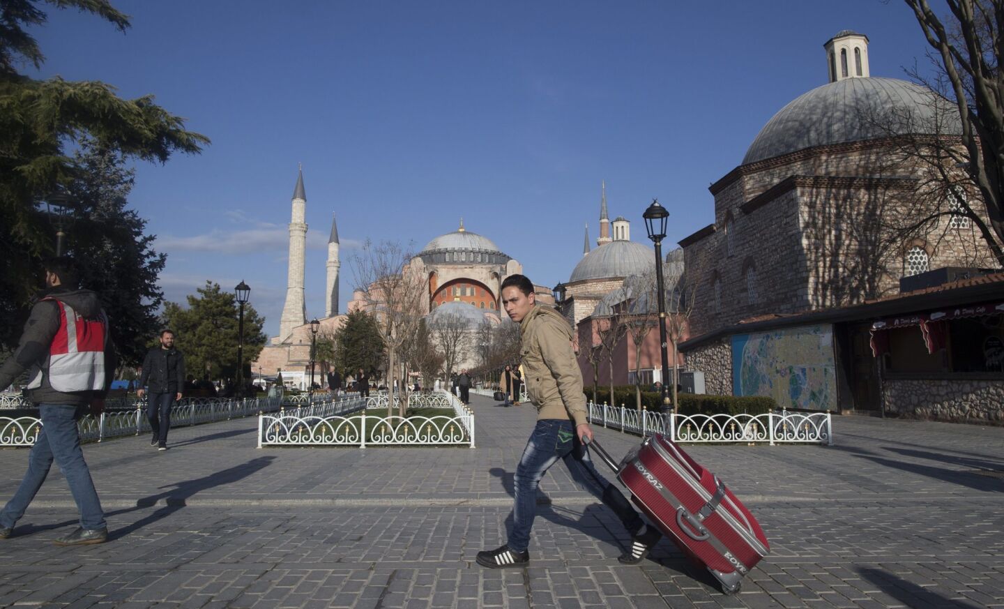 A tourist passes in front of Hagia Sophia Museum after an explosion at the nearby Blue Mosque.
