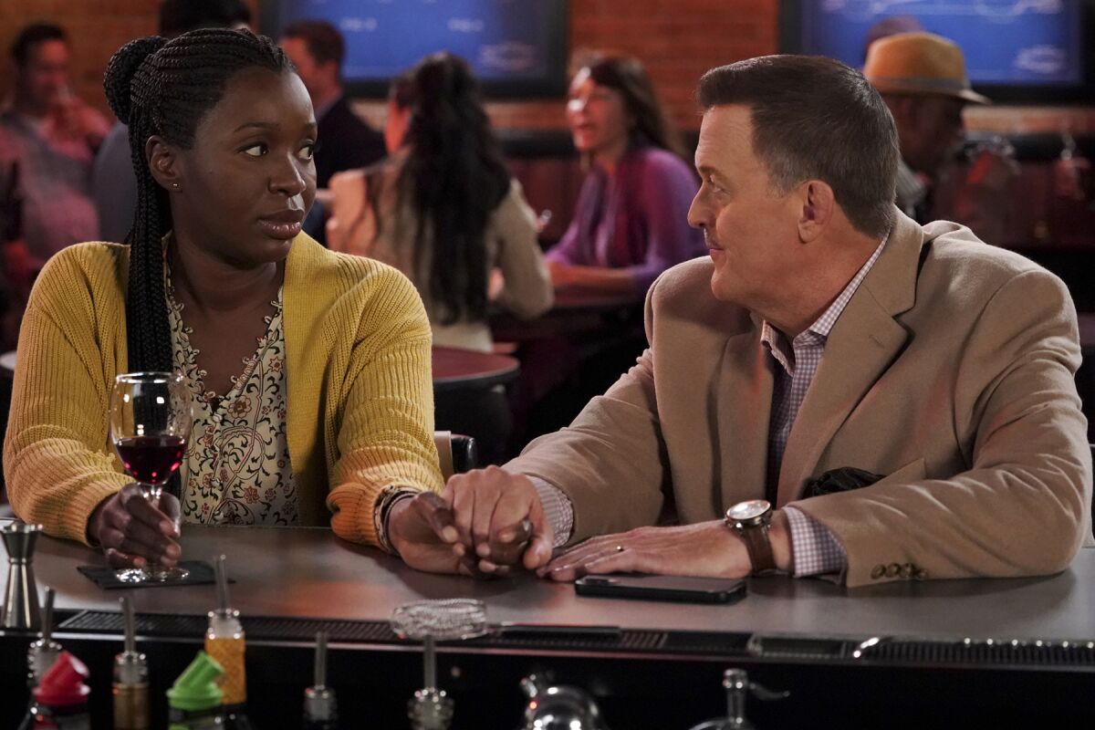 Folake Olowofoyeku, left, and Billy Gardell in "Bob Hearts Abishola" on CBS.