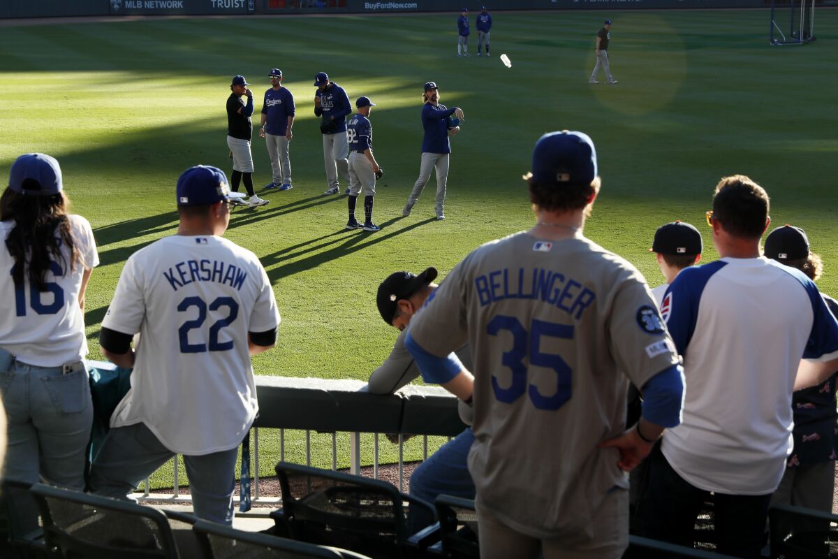 Dodgers fans watch as the team warm up before Game 6 of the NLCS against the Atlanta Braves at Truist Park on Saturday.