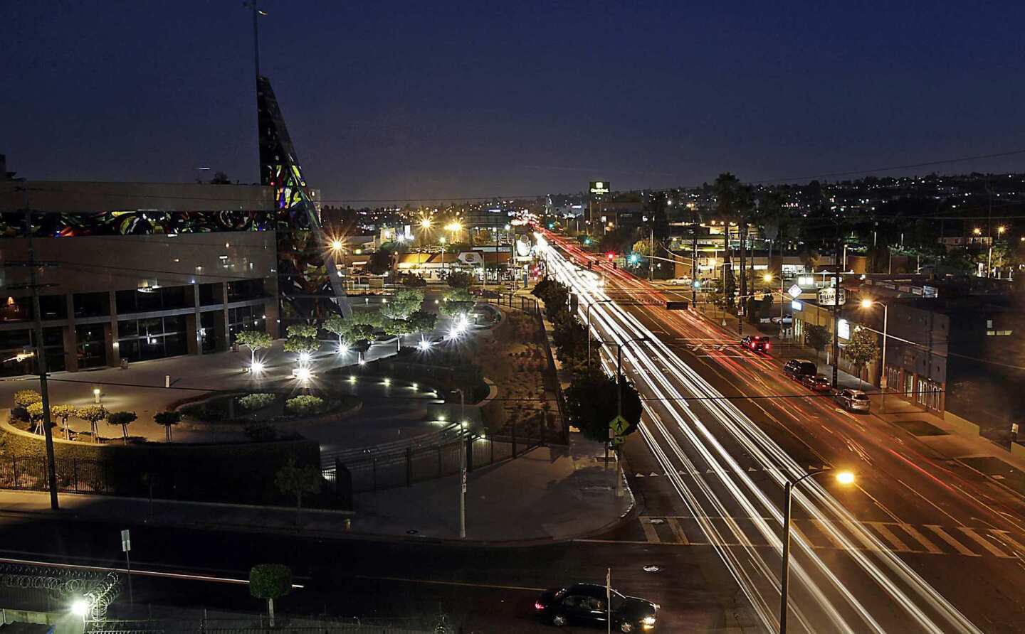 Traffic streams along Crenshaw Boulevard near its intersection with Exposition Boulevard in the Crenshaw district of Los Angeles. The district is about 60% African American. Prominent buildings along this stretch of the boulevard include the West Angeles Cathedral, left, the Baldwin Hills Crenshaw Plaza shopping center and the Angelus Funeral Home, which was designed by noted architect Paul R. Williams.