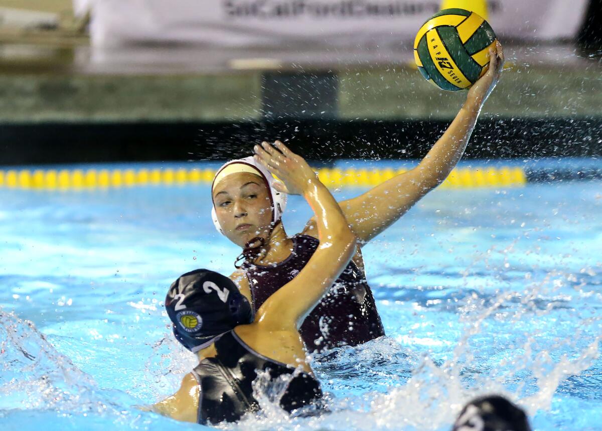 Laguna Beach's Emma Lineback takes a shot over Newport Harbor’s Taylor Smith and scores in the semifinals of the CIF Southern Section Division 1 playoffs at Irvine’s Woollett Aquatics Center on Wednesday.