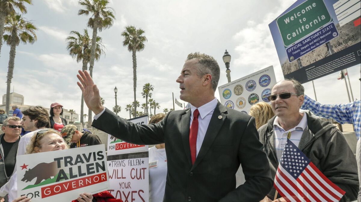 Assemblyman Travis Allen waves to supporters after announcing the receipt of more than 35,000 petitions he has received from people across the state encouraging elected leaders to opt out of a law making California a sanctuary state.