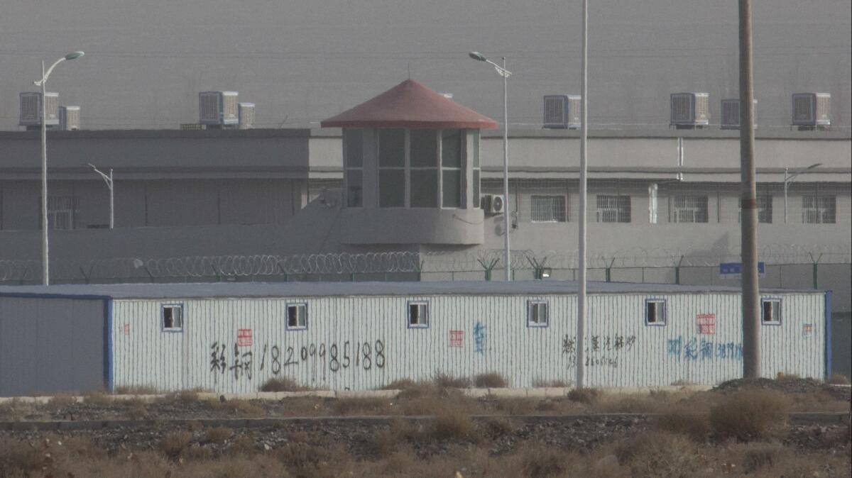 A guard tower and barbed wire fences are seen Dec. 3 around a facility in the Kunshan Industrial Park in Artux in western China's Xinjiang region. This is one of a growing number of internment camps in the Xinjiang region, where by some estimates 1 million Muslims are detained.