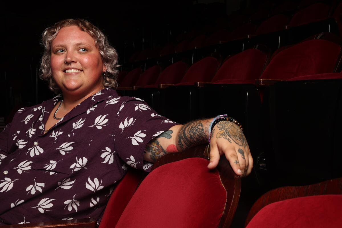 Asher Phoenix sits in a theater.