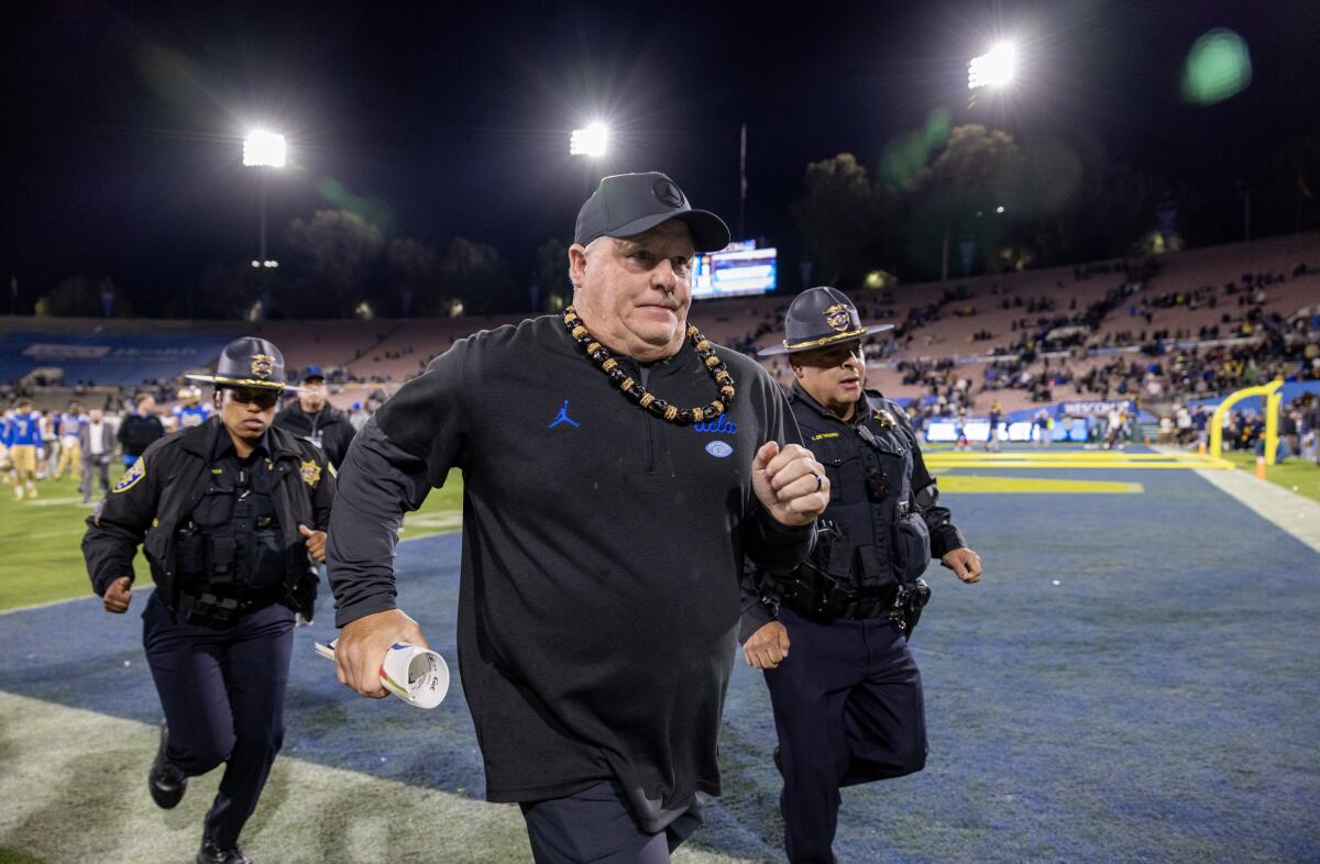 UCLA coach Chip Kelly runs off the field after his team's 33-7 loss to California at the Rose Bowl on Nov. 25.