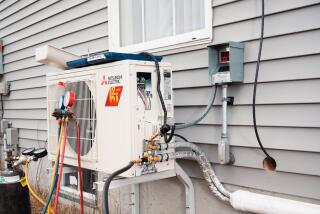 WINDHAM, ME - JANUARY 19: An electric heat pump, freshly installed by a crew from ReVision Energy, a New England company specializing in solar energy and electric heat pump installations, sits mounted to the side of a home in Windham, Maine on Thursday, January 19, 2023. Improved energy efficiency with heat pump technology and new tax incentives have contributed to the popularity of heat pumps in New England, as many homeowners are facing increased costs of heating their homes with oil, propane and other fossil fuels. (Photo by Tristan Spinski for The Washington Post via Getty Images)