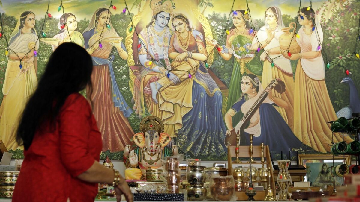 A painting of Krishna decorates a wall at Samosa House in Los Angeles. The market and restaurant on Washington Boulevard is one of the oldest South Asian businesses in the Palms and Culver City area, opening as Bharat Bazaar in 1979.