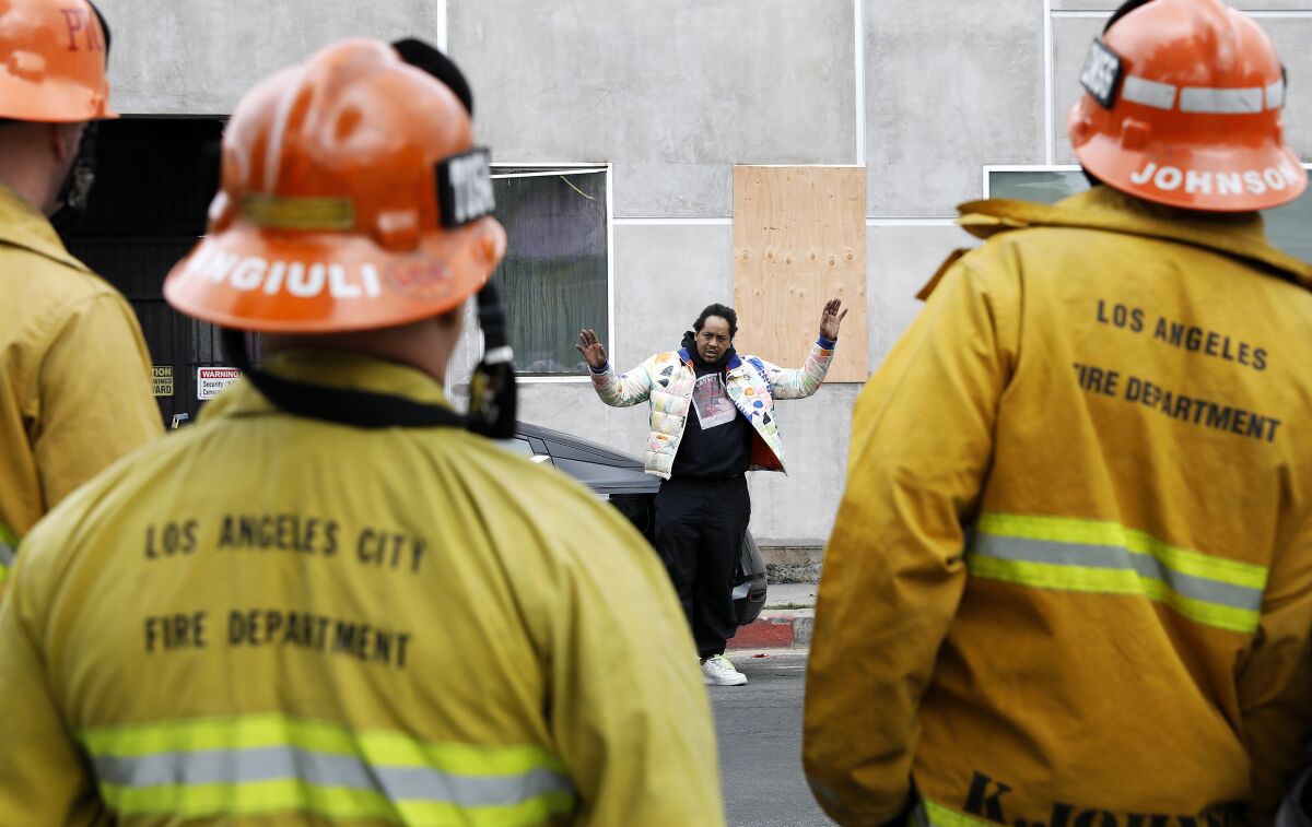 Jamal Davis describes to L.A. City Fire officials how he escaped the fire burning.