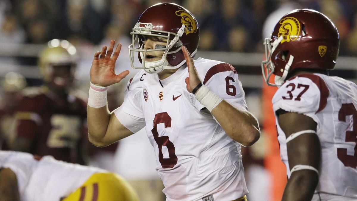 USC quarterback Cody Kessler calls an audible during Saturday's loss to Boston College. USC Coach Steve Sarkisian is re-evaluating the Trojans' run-first strategy in the wake of their meager rushing performance against the Eagles.