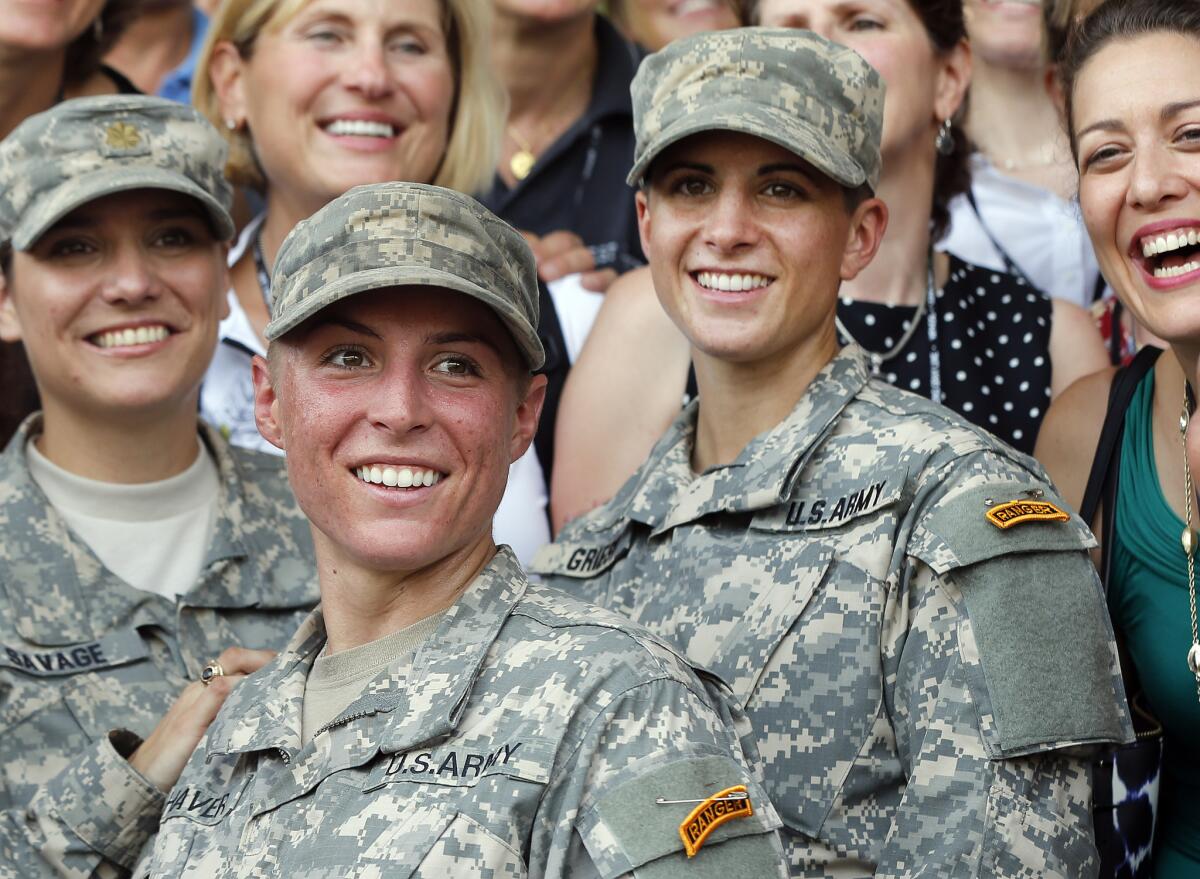 Army 1st Lt. Shaye Haver, center, and Capt. Kristen Griest, right, pose for photos with other female West Point alumni after an Army Ranger school graduation ceremony at Fort Benning, Ga. Haver and Griest became the first female graduates of the Army's rigorous Ranger School.