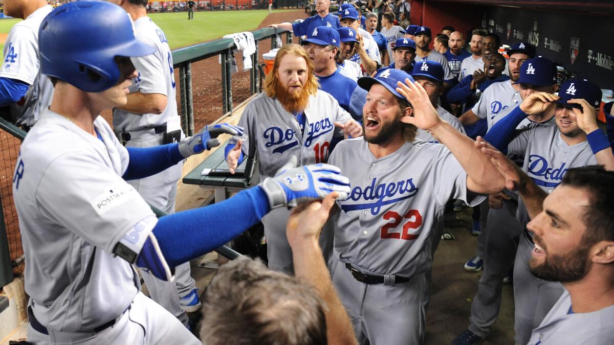 Cody Bellinger is mobbed by teammates after hitting a homerun.