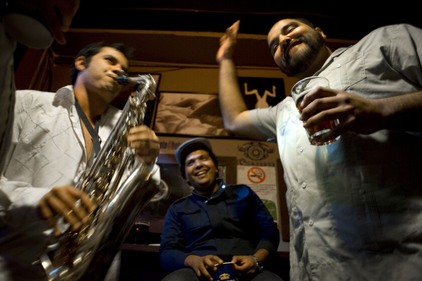 Abraham Aispuro plays the saxophone for friends at the "Zebra Mexican Pub" bar in Tijuana, Mexico along Tijuana's Sixth Street (Calle Sexta). (David Maung)